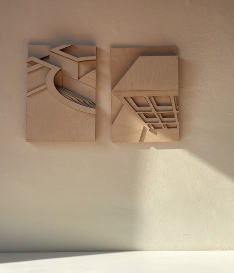 plywood relief pictures on a wall with sunlight casting shadow