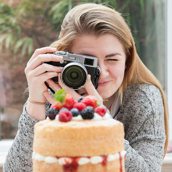 girl photographing cake