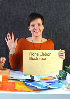 Fiona Clabon Illustration, working at her desk, waving 