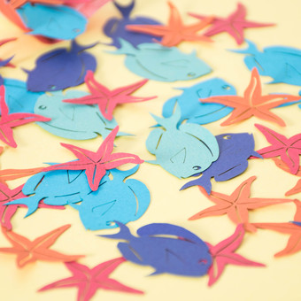 Under the Sea themed paper table confetti with fish and starfish