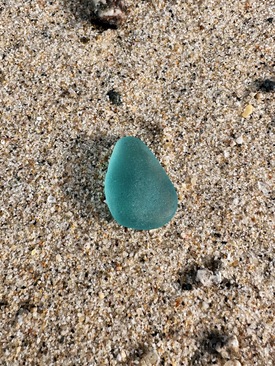 Turquoise sea glass on a beach in Cornwall