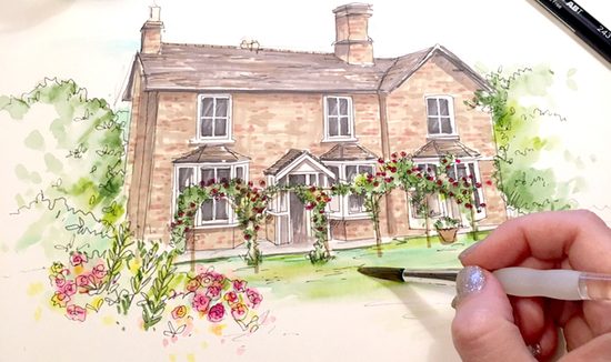 An action shot of a house being illustrated, showing the artists hand paintingfinishing touches to the scene