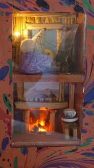 Miniature mouse house in a book,with a flickering fire and candle. This is the perfect nightlight