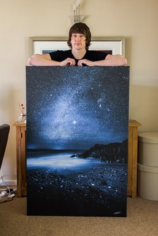 Chad with a 54x36" Canvas of 'Midnight Blue'