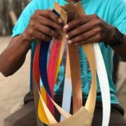 Artisan holding dyed natural straw leafs