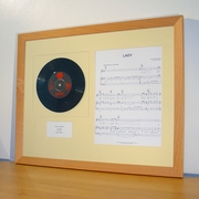 Framed vinyl single with sheet music