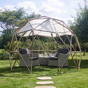The garden pod with table and chairs and shade sails