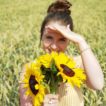 Sarah-jayne in a field with sunflowers