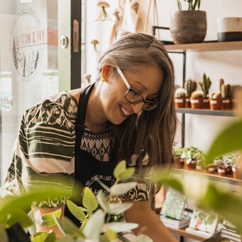 A woman tending to plants in a plant shop