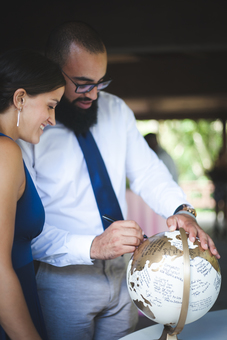 Wedding guests signing gold guestbook globe