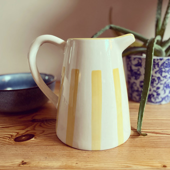 white and yellow striped jug