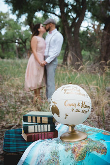 Couple with gold personalised globe engagement photoshoot