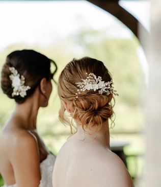 Brides wearing petal and pearl hair combs