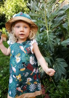 Bobbi's daughter, Izzie wearing a reversible, handmade 'Jungle' pinafore dress