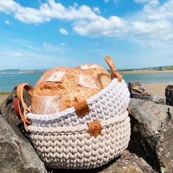 Image bread in crochet basket with leather handles