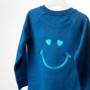 The LOVE sweatshirt features a beautifully embroidered smile and heart eyes on the reverse paired with the simplicity of Love in vibrant text on the front