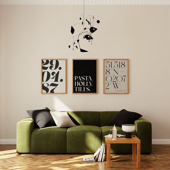 Three personalised prints on a wall; one with a custom date, one with custom what three words and one with custom coordinates. All prints using neutral colours