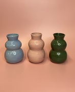 3 wavy vases in a dark green green, light pink and blue glaze