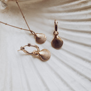 A shell necklace with matching hoops in gold