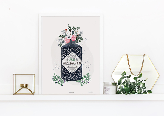 A framed gin and flowers bestselling print on a shelf by Emma Bryan Design