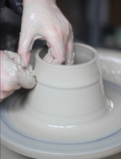 Throwing clay on the potter's wheel
