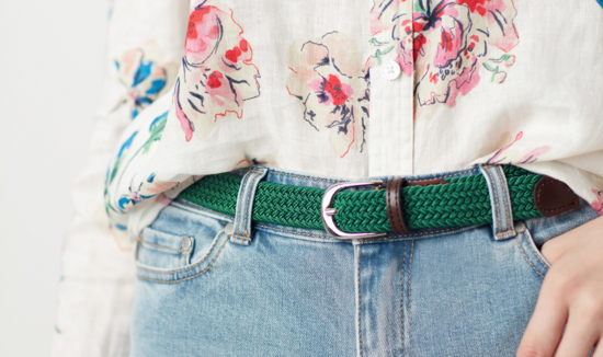lady wearing jeans and green woven polo belt