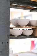 cearmic tweet bowls drying on studio shelves