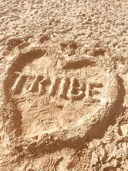 The first attempt by my daughters at our logo. Our swimwear logo drawn in the sand