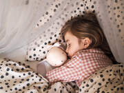 child asleep with cloth doll