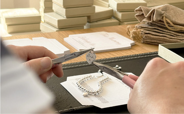 A teammate packaging a jewellery order