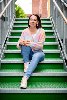 The Joyful Rebel owner sitting on green steps