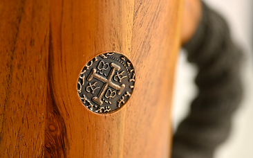 close up of chuug wooden beer tankard viking pirate metal coin replica and black rope handle on the side