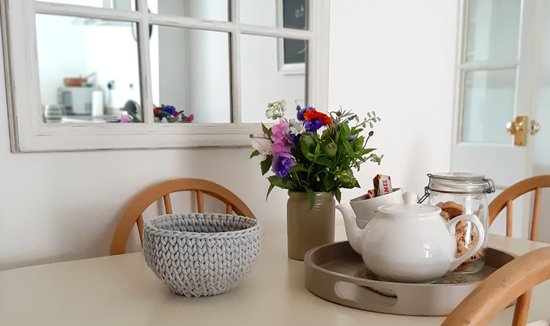 Kitchen table featuring crochet basket