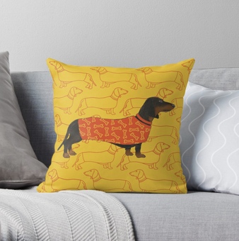 A colourful cushion featuring a Dachshund. Steve is wearing a designer coat and he sits on a background with another exclusive pattern designed by me.