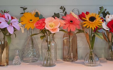 Crepe paper flowers in glass vases