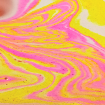 Bath bomb in action. Pink and yellow bath art