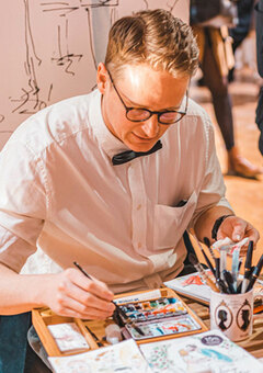 Myself drawing portraits at an event