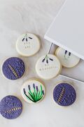White and purple biscuits with icing painted with lavendar plants