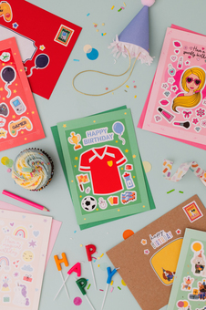 A gaming sticker sheet, a football themed sticker sheet, a pink doll sticker sheet and a unicorn and rainbows sticker sheets on birthday cards feature