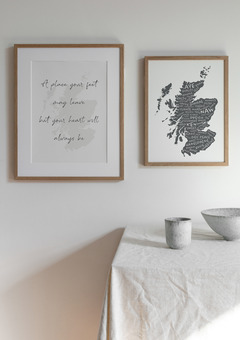 An image of two different map of Scotland prints on a wall