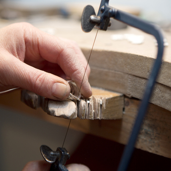Cutting silver rings with a jewellers saw