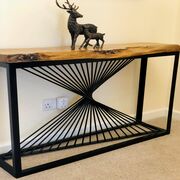 This handcrafted console table with an exquisite swirl of steel is combined with a stunning piece of Locally Sourced Oak to create a purposeful piece of art.