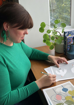 Victoria Oatway, owner and designer of Bobbie Print signing prints in her home studio.