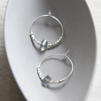 These are the Sterling Silver And Labradorite Hoops. I love working fair trade precious metal nuggets into my pieces, which are shown here in fine silver. 