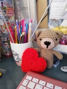 Crochet bear with heart and crochet hooks