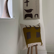 Twofolde collaged linen appliqué cushion and wall hanging featuring abstracted shapes and lines.