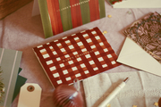 an adorable, red gingham patterned christmas card with gold foiling