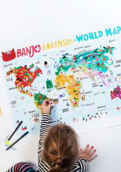 Child adding sticker to Banjo's big, beautiful world map. 