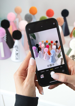 Woman taking a photo of custom personalised first birthday party hats