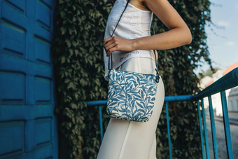 Woman wearing Signare tapestry design bag